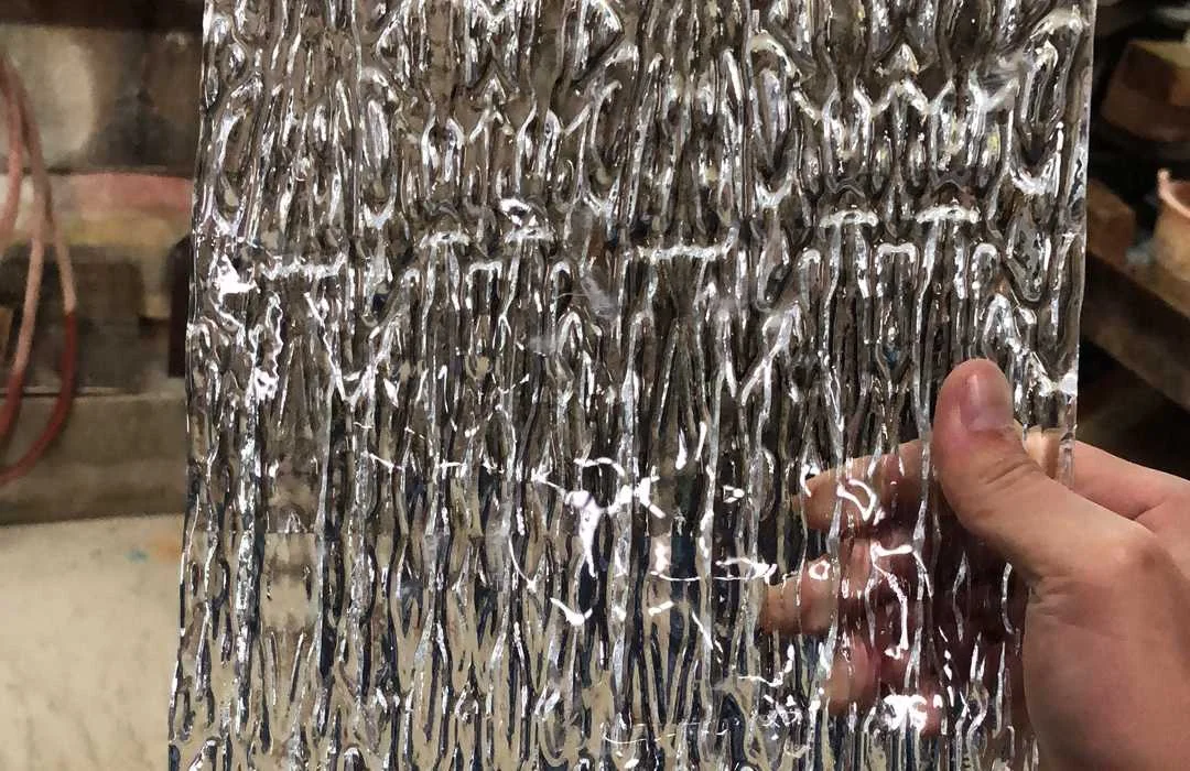 A textured glass sample held for examination