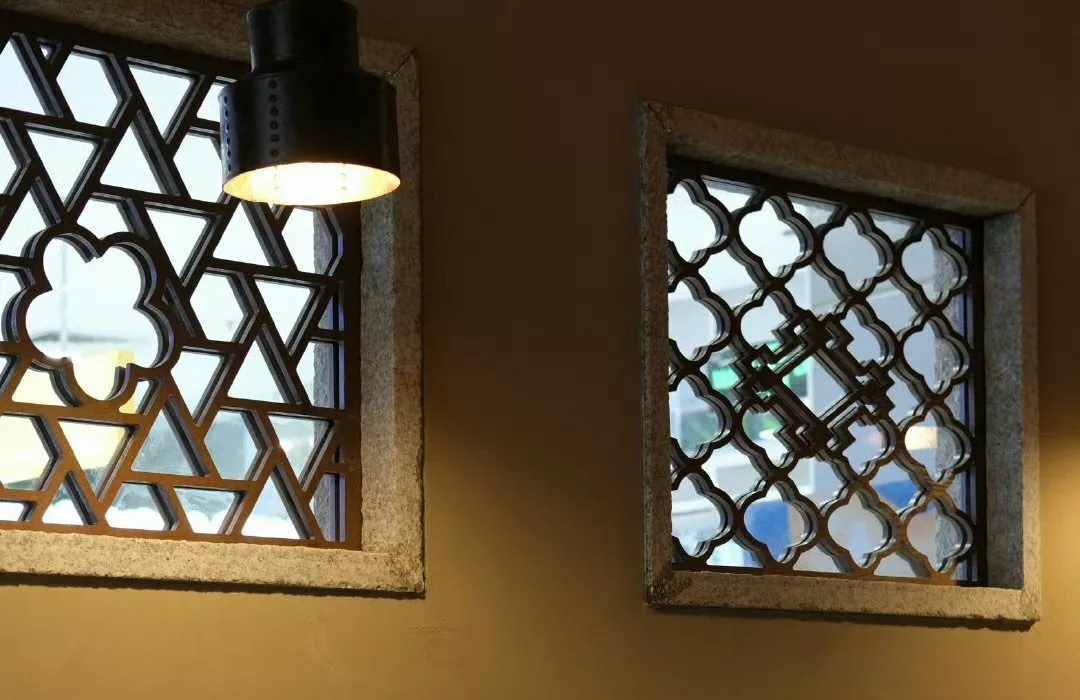 A pendant light beside decorative windows in the RUXU interior