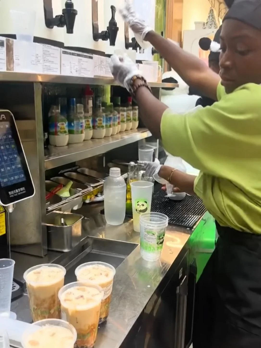 A view of drinks preparation at the panda-themed tea shop in Abidjan, from the owner’s video cover.