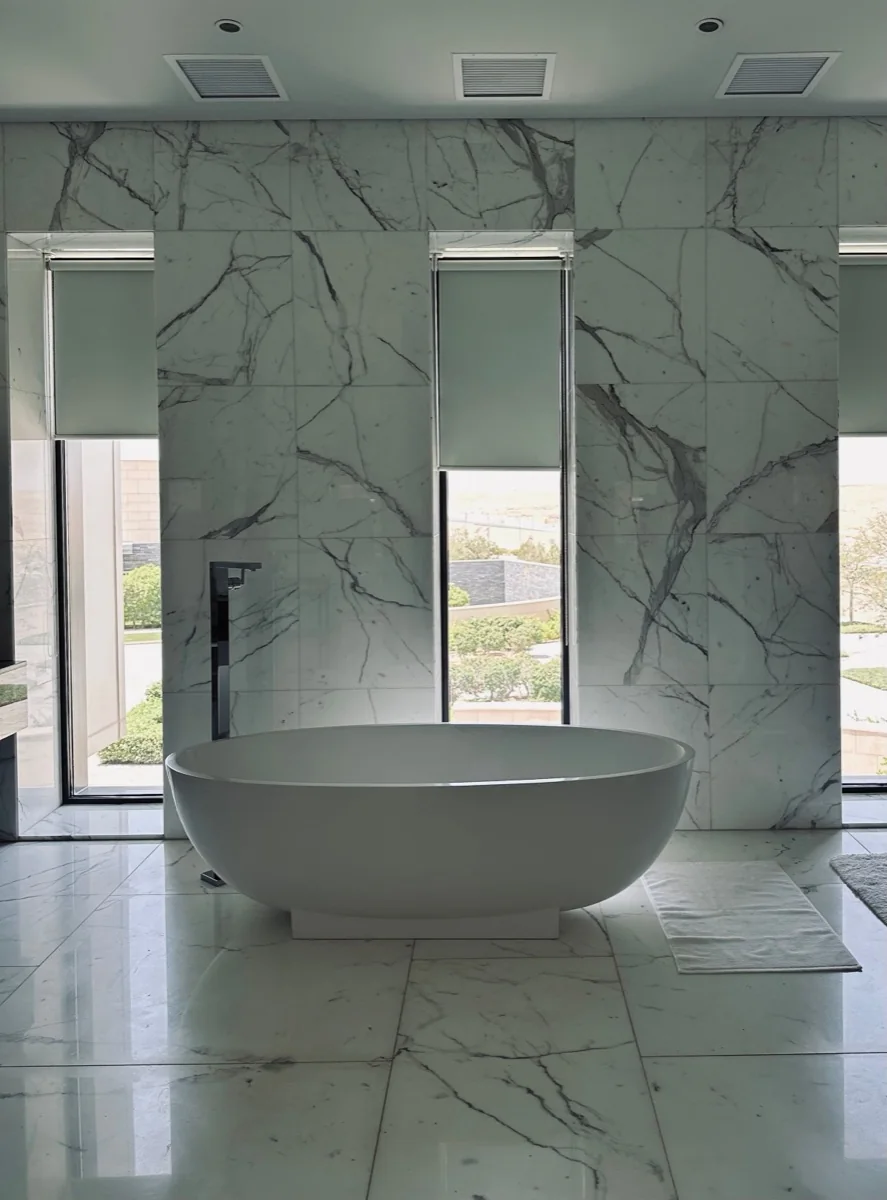 Bookmatched marble slabs on a bathroom wall