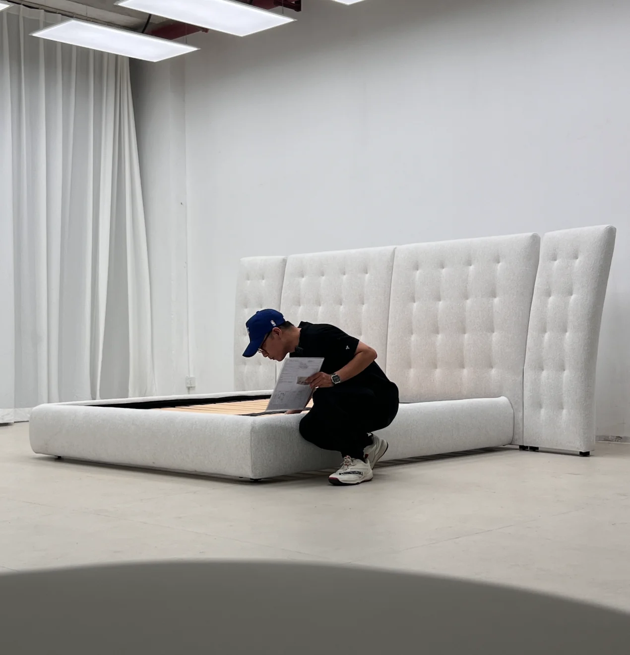 Checking an upholstered bed against a printed reference sheet